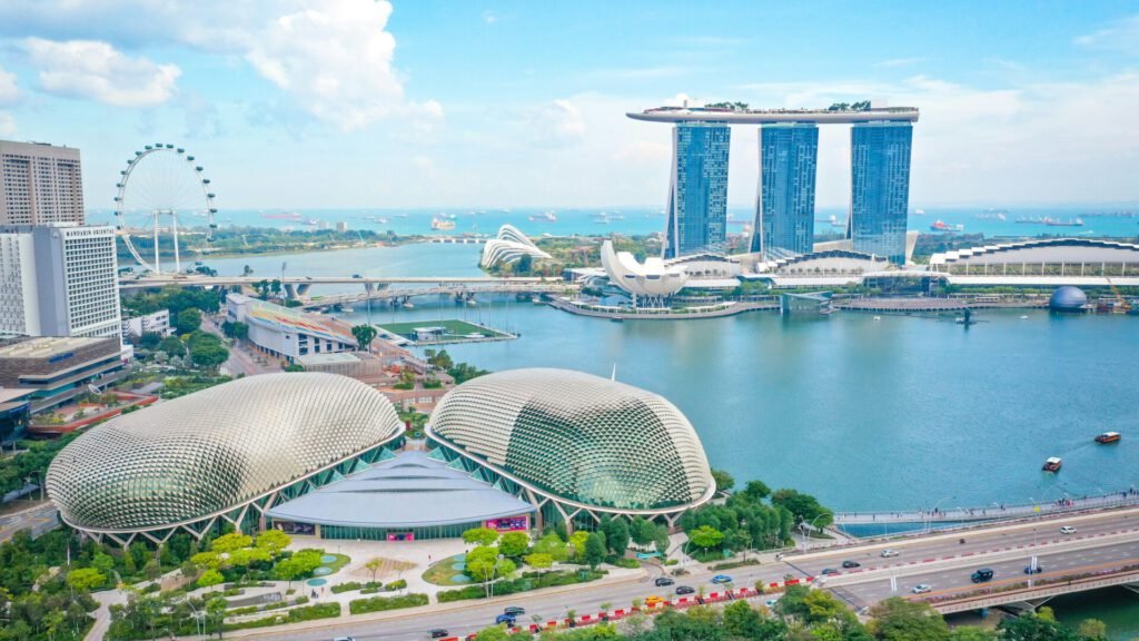 Singapur Eine Luftaufnahme von Singapur mit Marina Bay Sands und der Straße von Singapur im Hintergrund